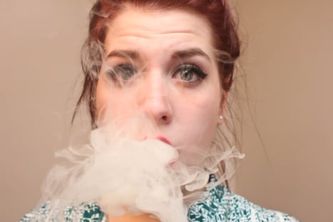 Woman exhaling smoke