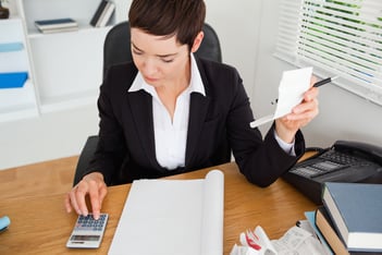 Active accountant checking receipts in her office