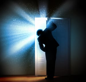 Image of young businessman standing with back opening door