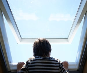 Kid at home by the roof window