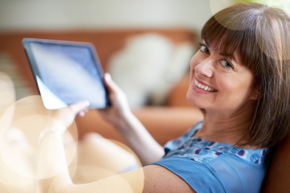 Mature woman browsing the internet on a digital tablet