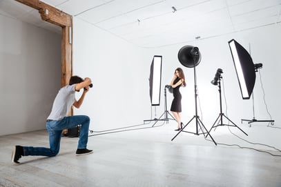 Photographer working with model in studio with equipments