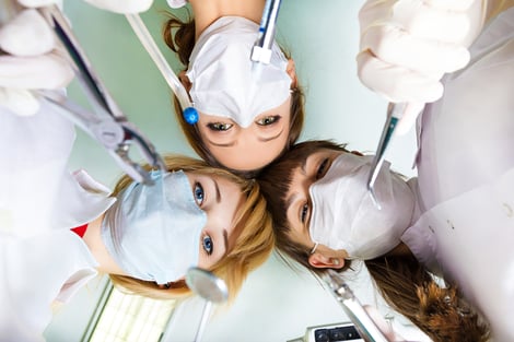 View of doctors, dentists holding surgical instruments, by patient after operation on background of lamp, ceiling. Patient hospital, intensive care unit visit, emergency hospitalization