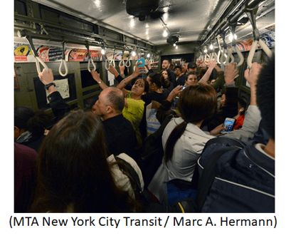 Crowd of commuters on New York subway.